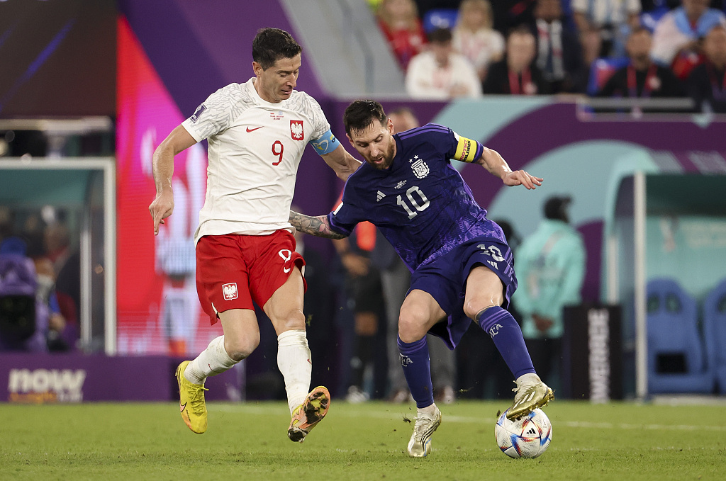 Argentina captain Lionel Messi (R) and Robert Lewandowski of Poland fight for the ball during their World Cup clash at Stadium 974 in Doha, Qatar, November 30, 2022. /CFP