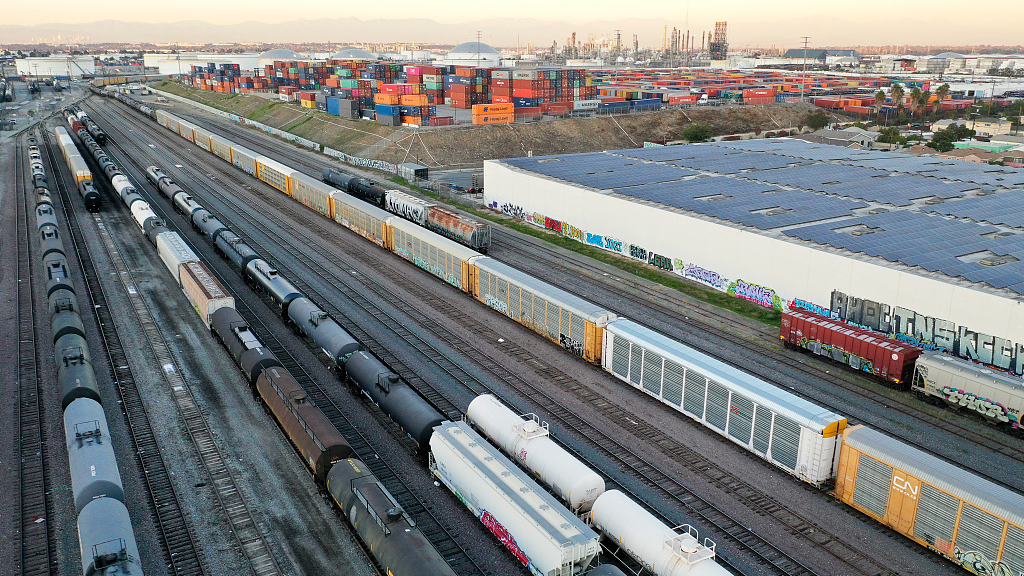 An aerial view of freight rail cars in a rail yard near shipping containers in Wilmington, California, U.S., November 22, 2022. /CFP