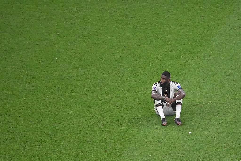 Germany defender Antonio Rudiger sits alone on the pitch after his side suffered the ignominy of crashing out of the World Cup at the group stage for the second successive tournament at the Al Bayt Stadium in Al Khor, Qatar, December 2, 2022. /CFP