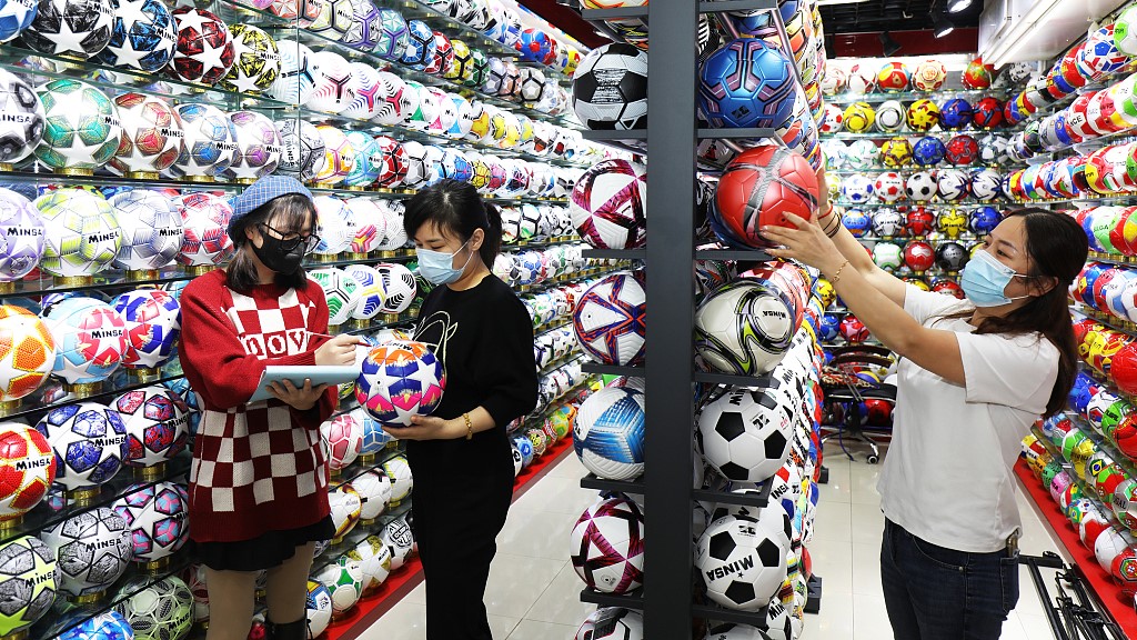 Customers browse footballs at a store in Yiwu city in east China's Zhejiang Province, October 31, 2022. /CFP