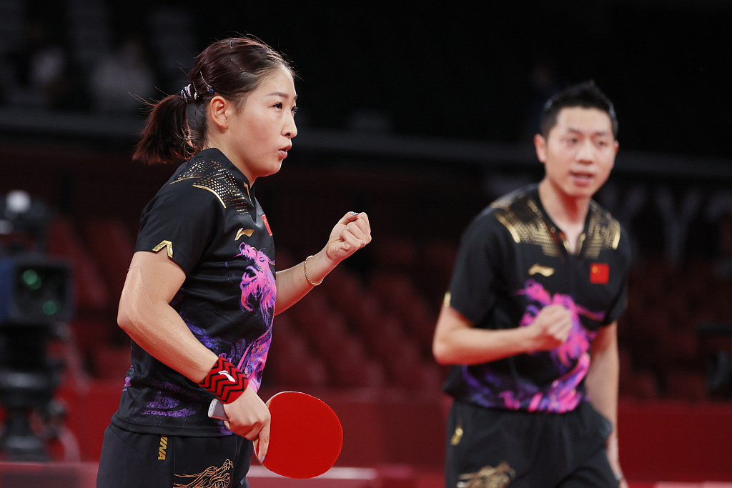 Liu Shiwen (L) and Xu Xin of Team China celebrate a point during their mixed doubles semi-final at the Tokyo 2020 Olympic Games in Japan, July 25, 2021. /CFP