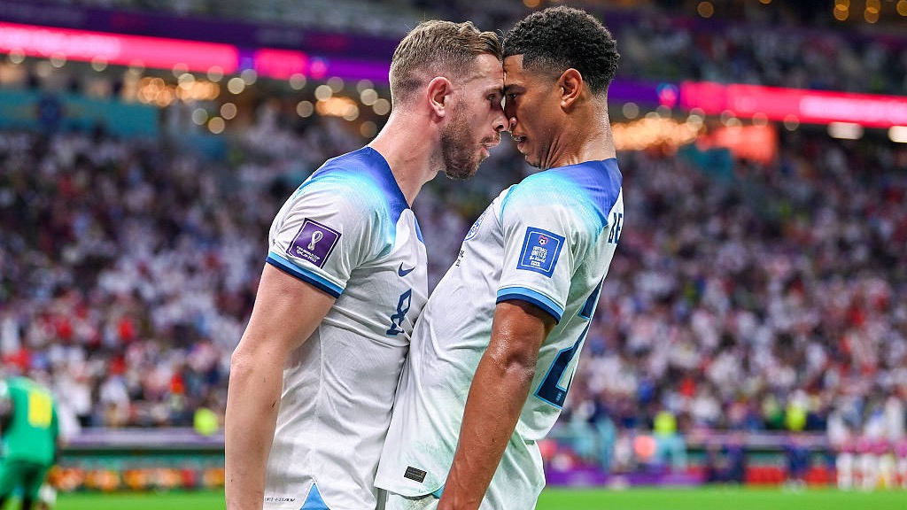 England's Jordan Henderson (L) and Jude Bellingham react after their team's first goal during their World Cup clash with Senegal at the Al-Bayt Stadium in Al Khor, Qatar, December 4, 2022. /CFP