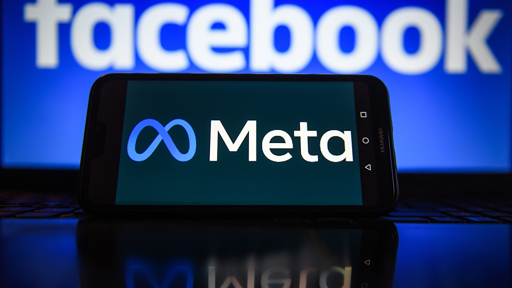 Meta logo on a smartphone with Facebook logo in the background. /CFP