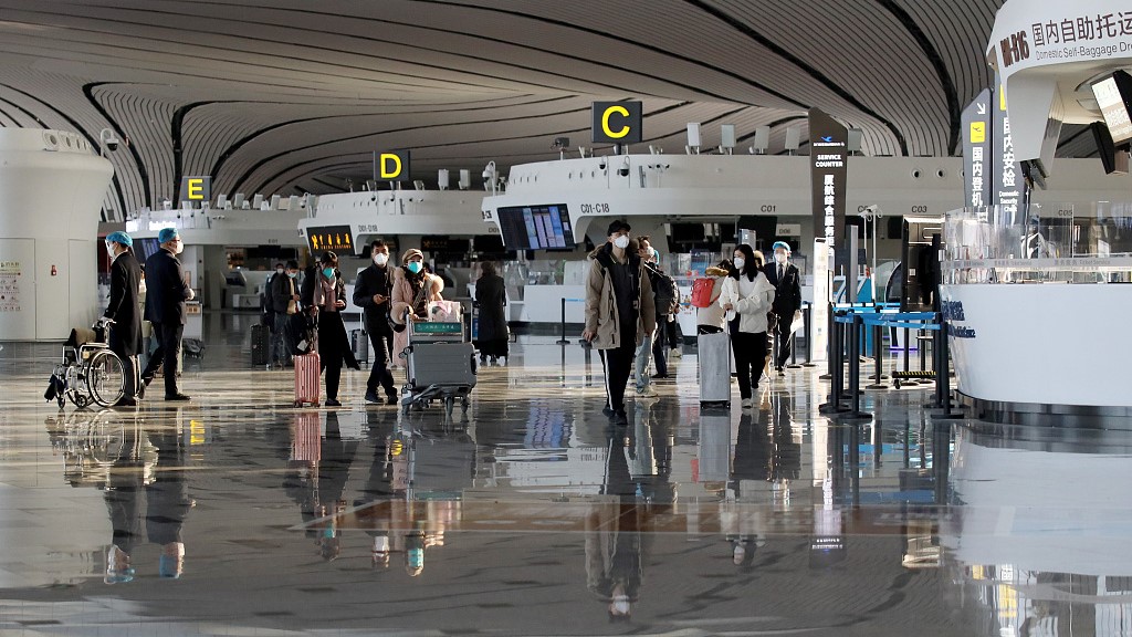 Travelers check in at the Beijing Daxing International Airport, December 8, 2022. /CFP