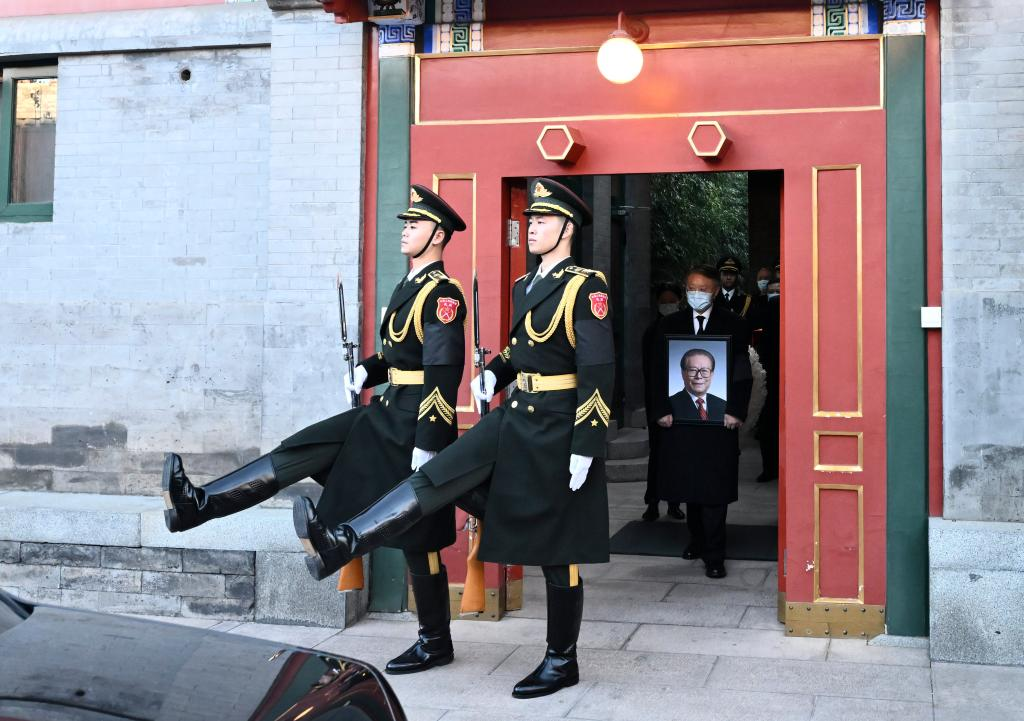 Jiang Zemin's family members holding Jiang's portrait, cinerary casket and a wreath walk out of Laifu Hall in Zhongnanhai in Beijing, capital of China, December 11, 2022. The ashes of beloved Comrade Jiang Zemin were scattered into the sea at the estuary of the Yangtze River on Sunday, in accordance with the wishes of Jiang himself and his family. /Xinhua