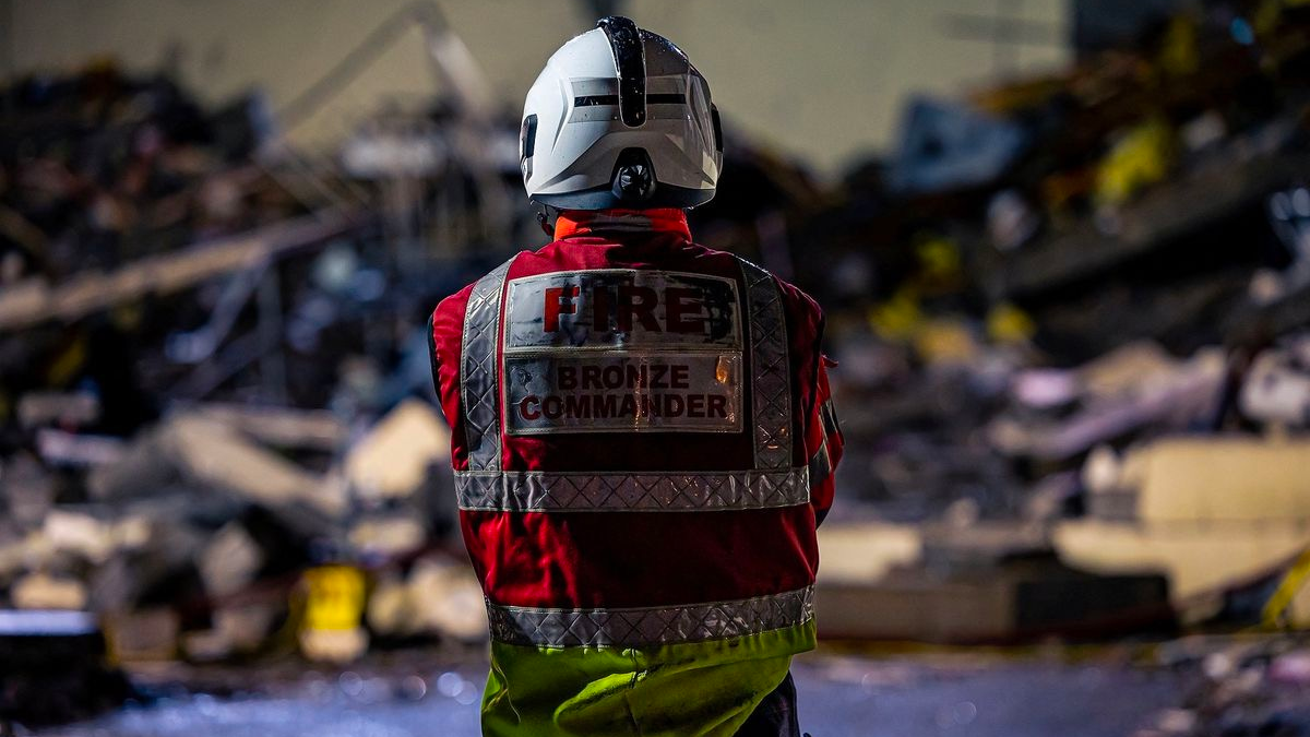 A member of a search crew works at a blast site at a block of flats in Saint Helier, on the island of Jersey, December 10, 2022. /Reuters