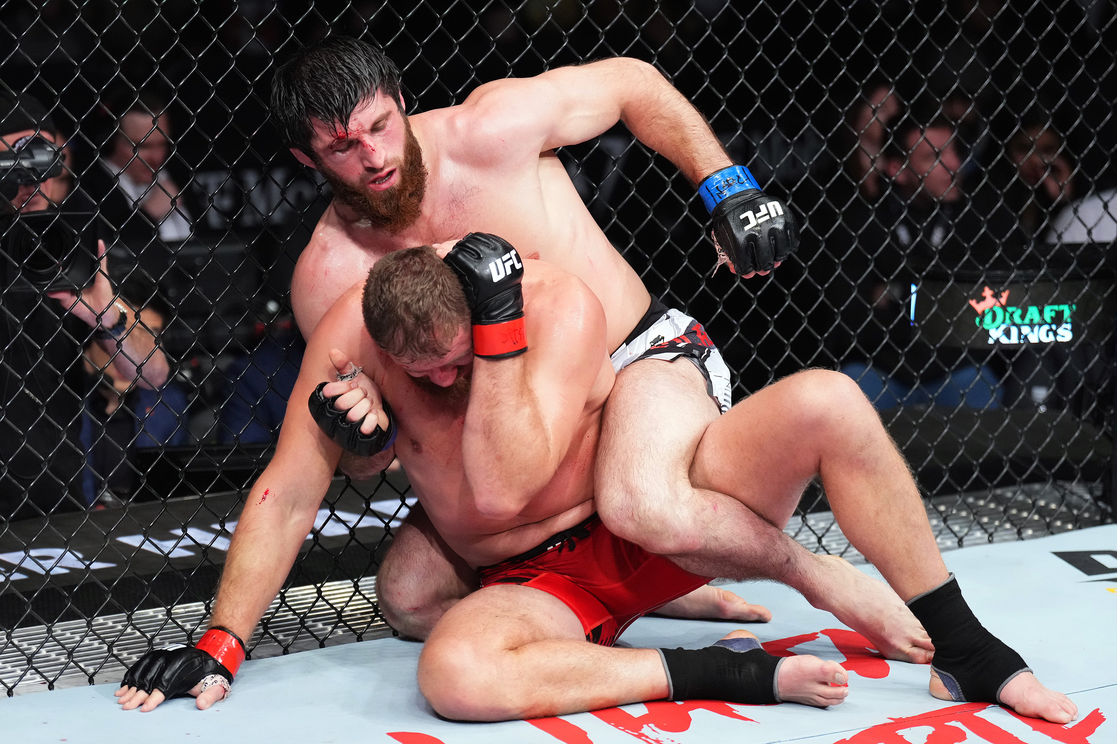 Magomed Ankalaev attempts strikes from the back of Jan Blachowicz. /Zuffa
