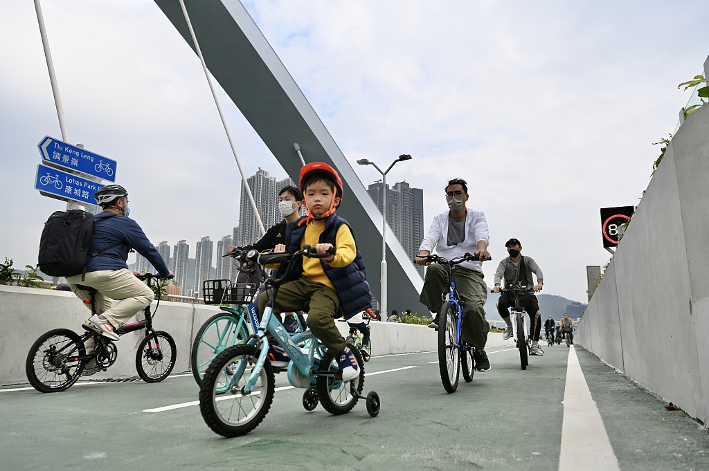 People ride bicycles on the Tseung Kwan O Cross Bay Bridge in Hong Kong, December 11, 2022. /CFP 