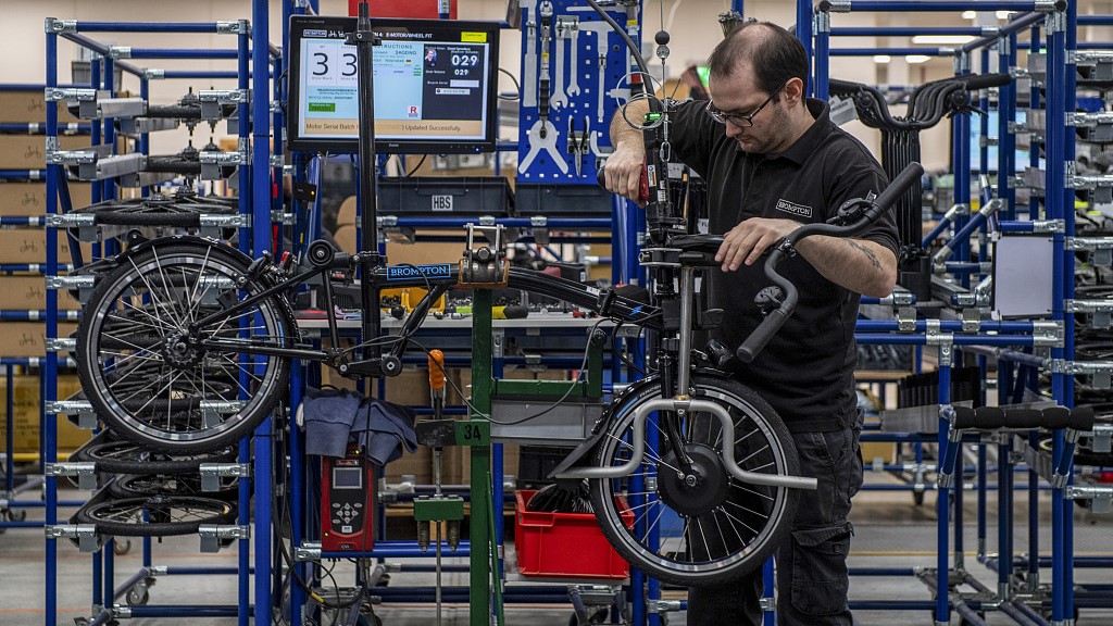 An employee works on a folding bicycle at the Brompton Bicycle factory in Middlesex, UK, March 10, 2020. /CFP