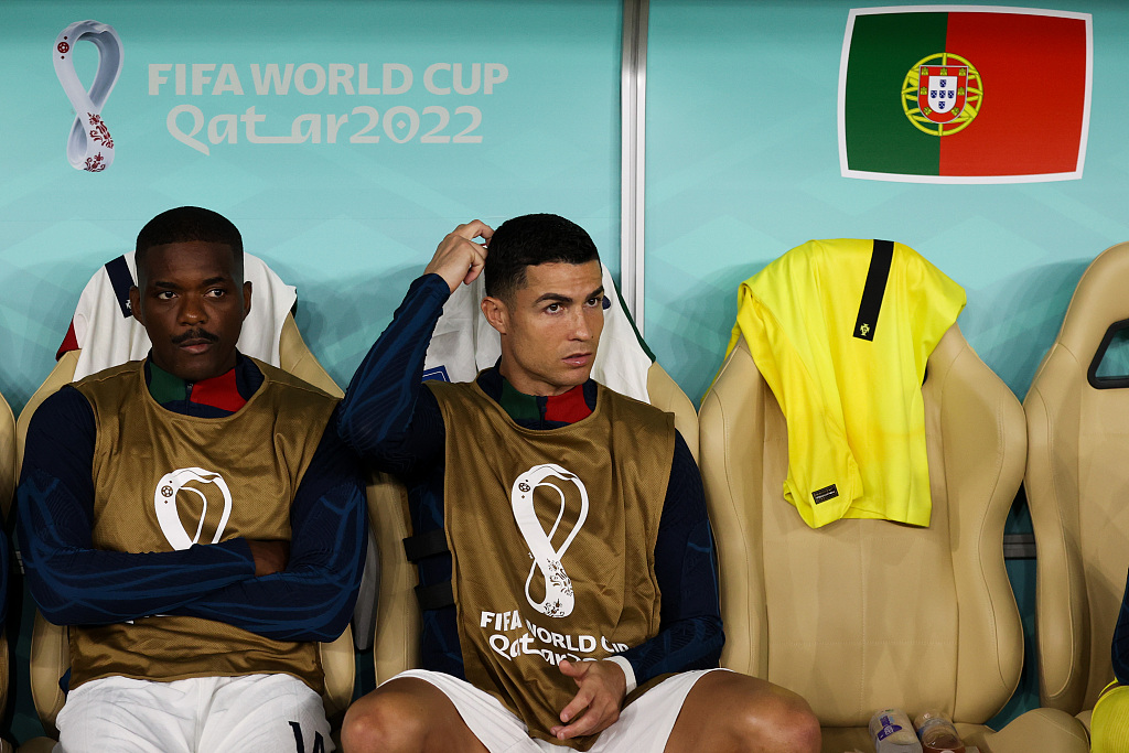 Cristiano Ronaldo (R) of Portugal sits on the bench during their World Cup clash with Morocco at Al Thumama Stadium in Doha, Qatar, December 10, 2022. /CFP