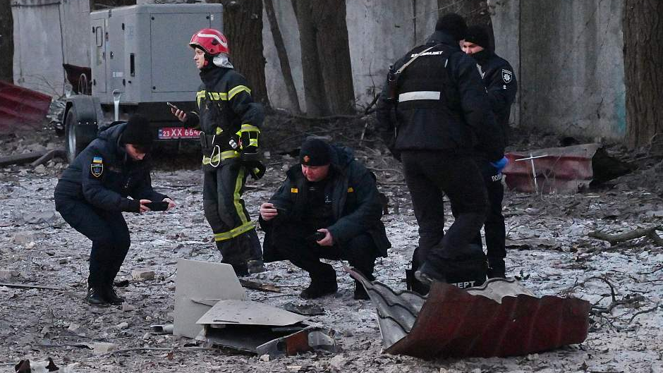 Rescuers and police experts examine remains of a drone following a strike on an administrative building in Kyiv, Ukraine, December 14, 2022. /CFP