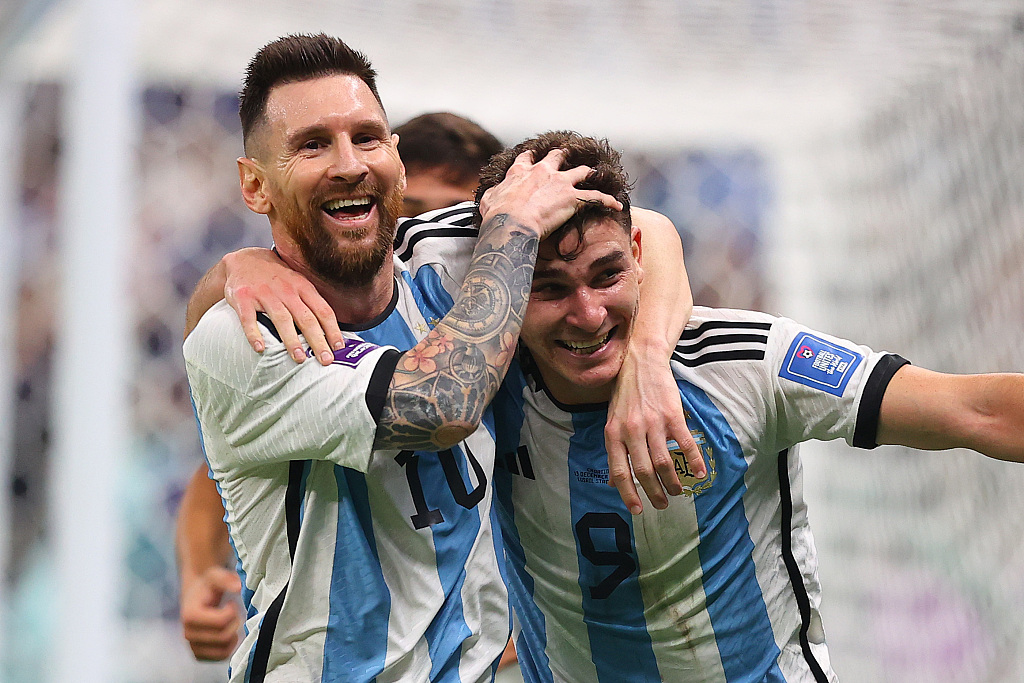 Lionel Messi (L) and Julian Alvarez celebrate after Alvarez scores a goal in the FIFA World Cup semifinals against Croatia at the Lusail Stadium in Qatar, December 13, 2022. /CFP