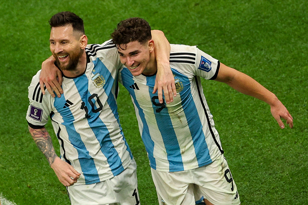 Argentina's Lionel Messi (L) and Julian Alvarez celebrate after the latter scored his team's second goal against Croatia in the World Cup semifinal round in Lusail City, Qatar, December 13, 2022. /CFP
