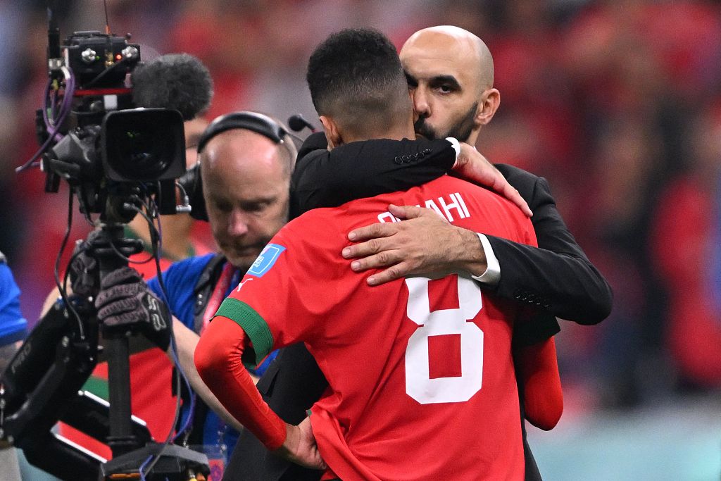 Morocco coach Walid Regragui embraces his midfielder Azzedine Ounahi after their World Cup loss to France at Al Bayt Stadium in Al Khor, Qatar, December 14, 2022. /CFP