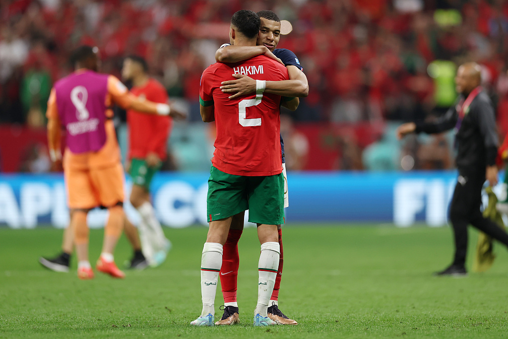 France's Kylian Mbappe embraces Morocco's Achraf Hakimi after their World Cup semifinal match, 2022. /CFP