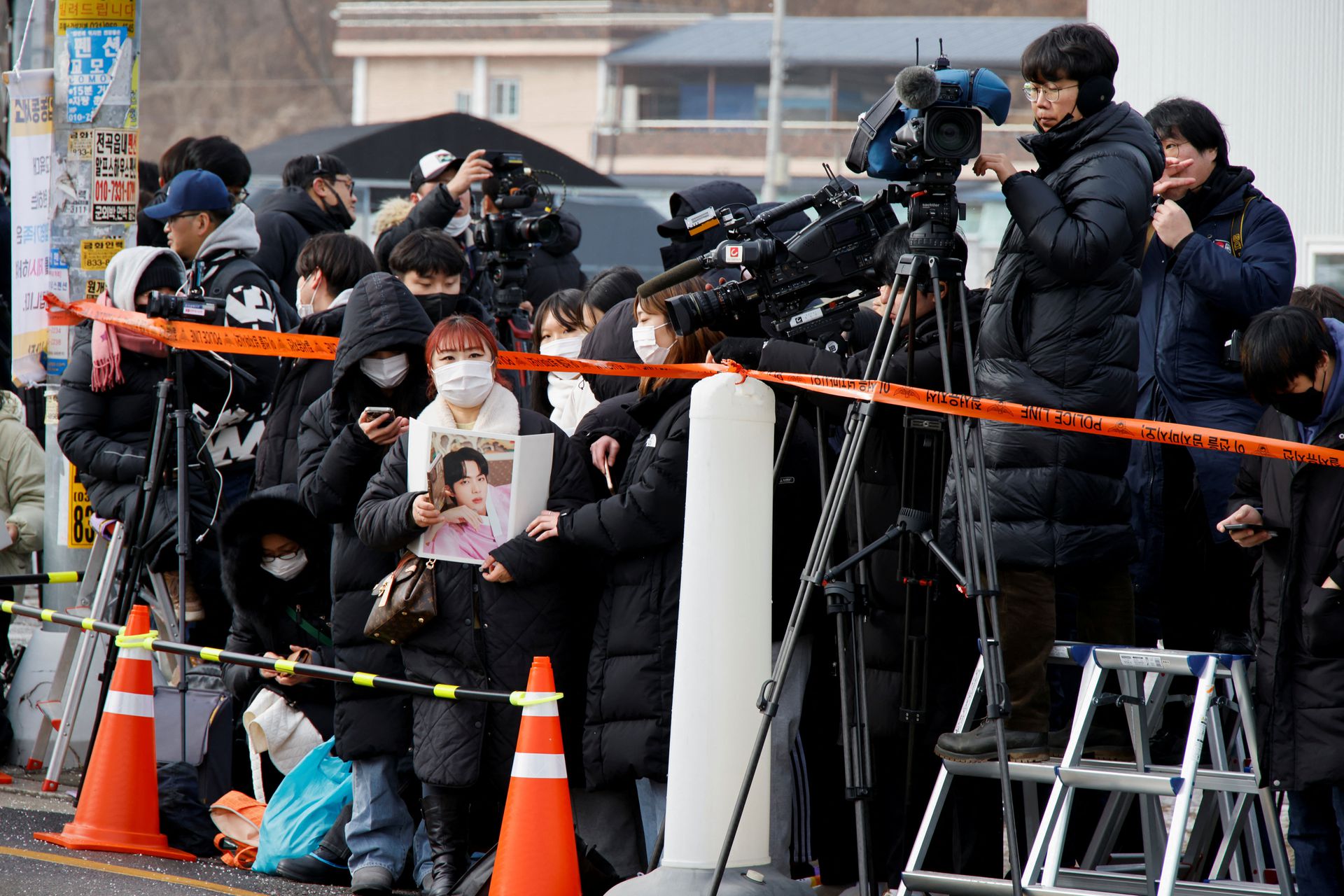 Fans and the media wait for the arrival of Jin, the oldest member of the K-pop band BTS, at a South Korean army boot camp near the demilitarized zone separating the two Koreas, in Yeoncheon, ROK, December 13, 2022. /CFP