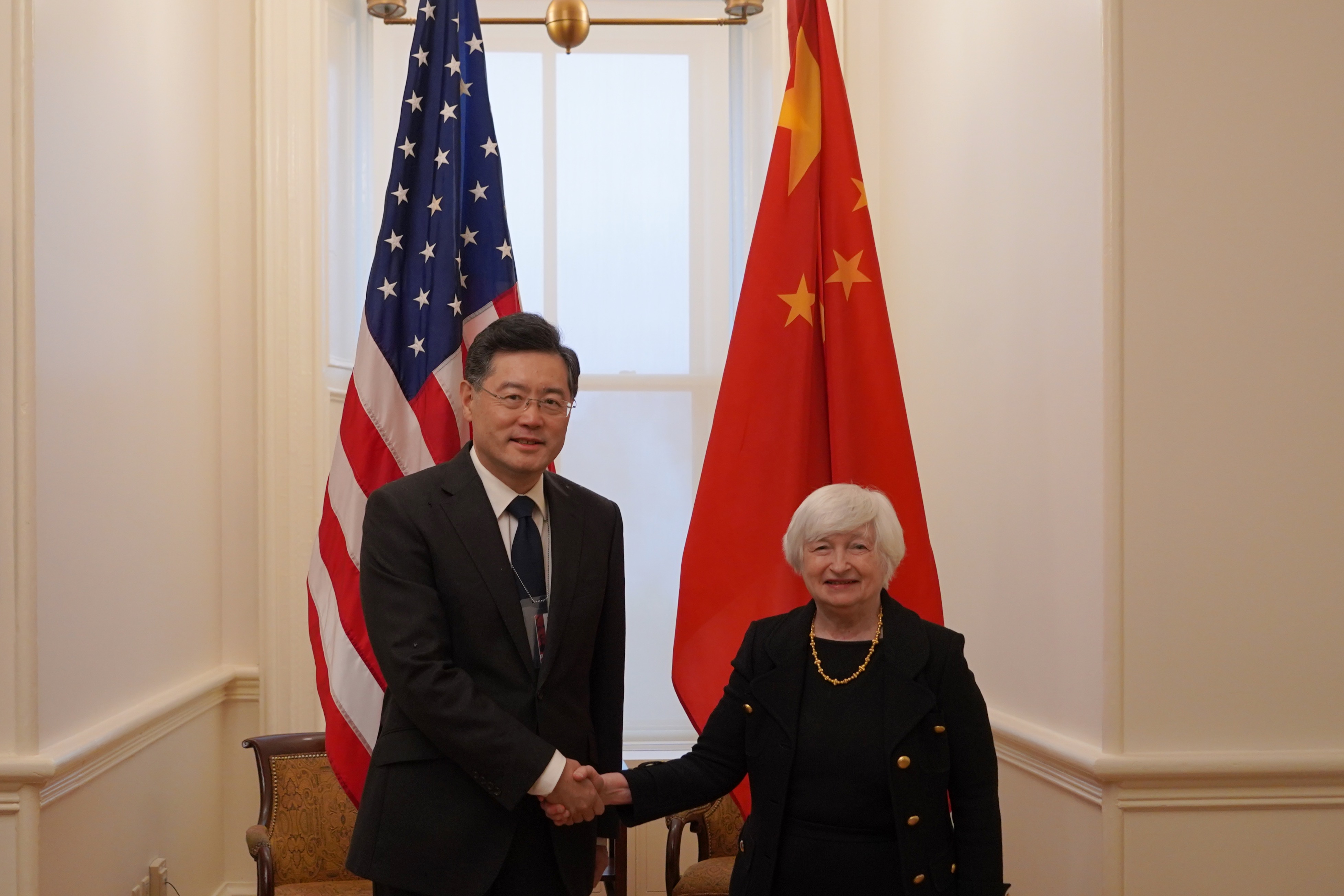 Chinese Ambassador to the U.S. Qin Gang (L) shakes hands with U.S. Secretary of the Treasury Janet Yellen during their meeting in Washington, D.C., the U.S., December 15, 2022. /Chinese embassy in Washington