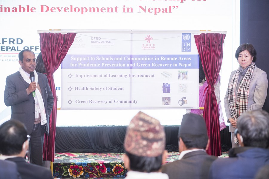 Vijaya Singh (L), assistant resident representative of UNDP Nepal, talks about a post-epidemic recovery project for Nepal's remote areas in Lalitpur, Nepal, December 16, 2022. /Xinhua