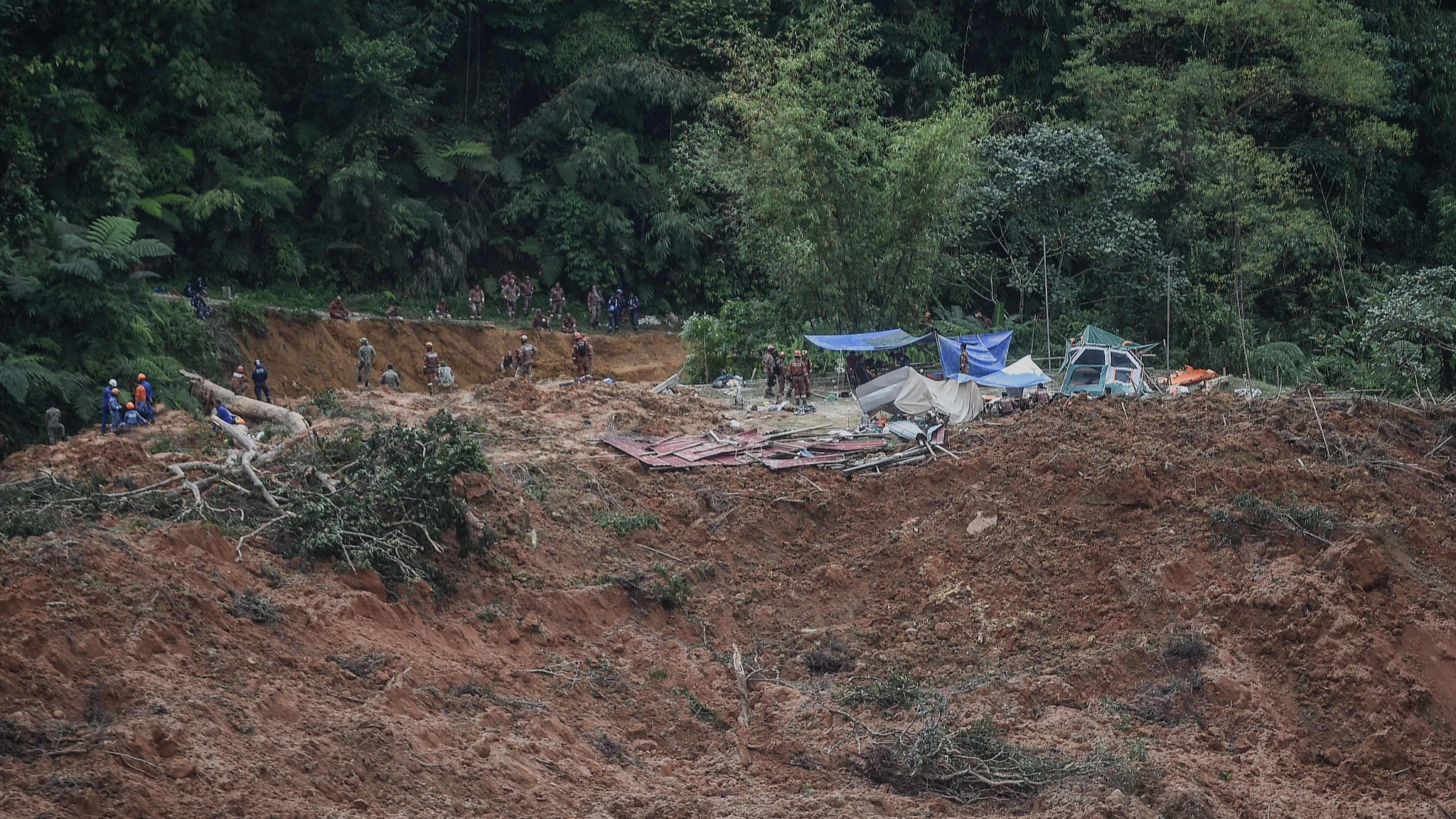 Malaysia's authorities inspect the site damaged after a landslide in Batang Kali, Selangor, December 16, 2022. /CFP