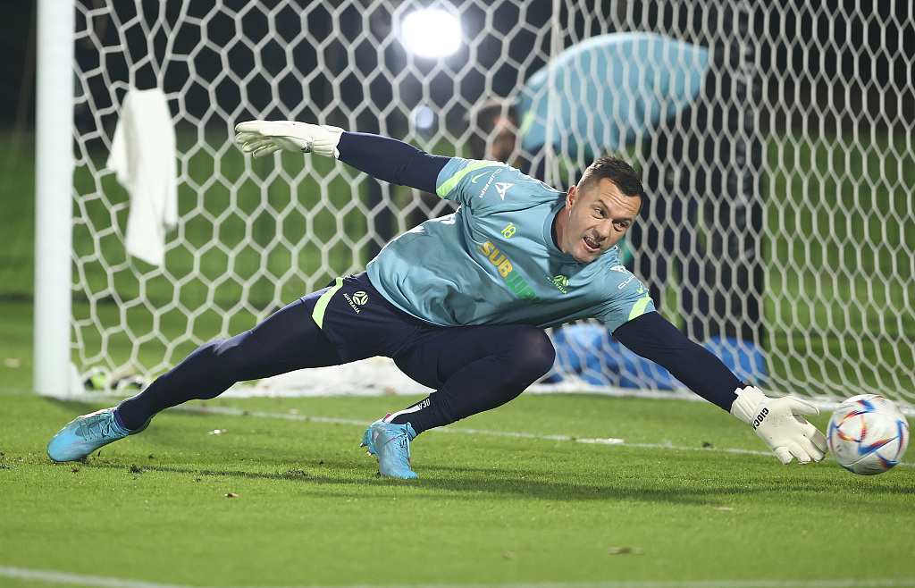 Danny Vukovic of Australia dives for the ball during a training session in Doha, Qatar, November 19, 2022. /CFP
