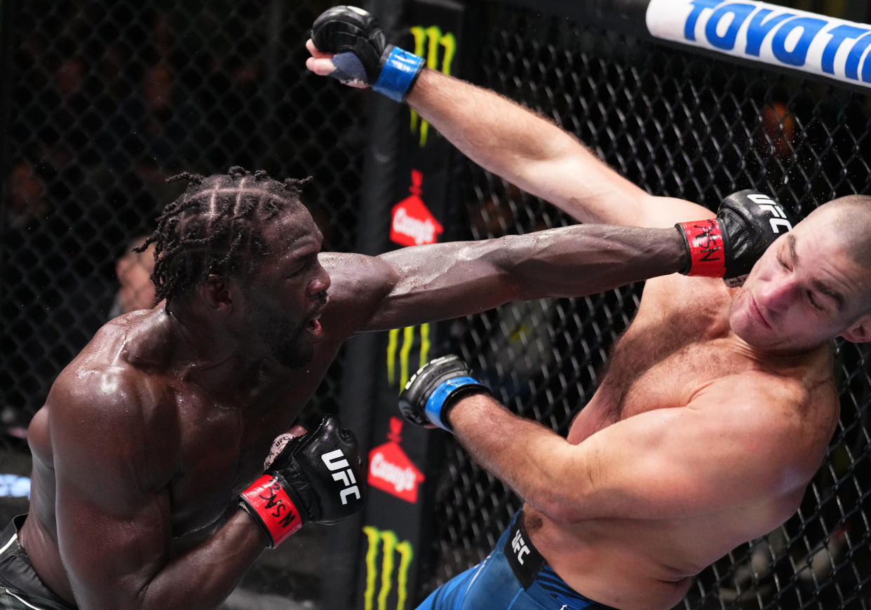 Jared Cannonier hits Sean Strickland with a jab of his own. /Zuffa