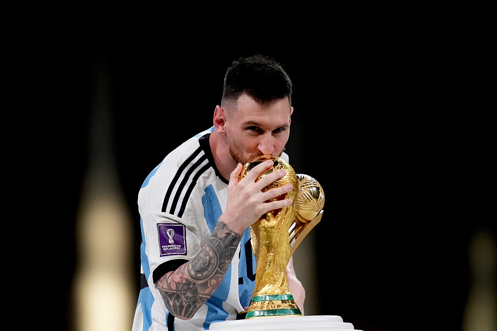 Lionel Messi of Argentina kisses the FIFA World Cup championship trophy after defeating France over penalties in the tournament's final at Lusail Stadium in Qatar, December 18, 2022. /CFP