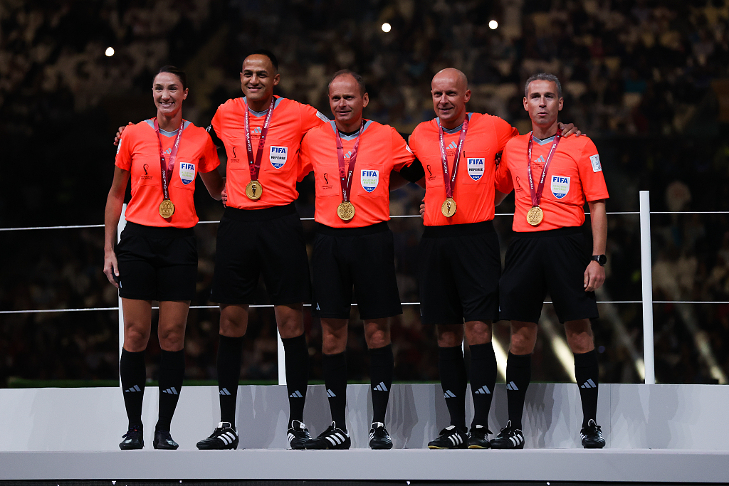 The match officials pose with their medals after the World Cup final between Argentina and France in Lusail City, Qatar, December 18, 2022. /CFP