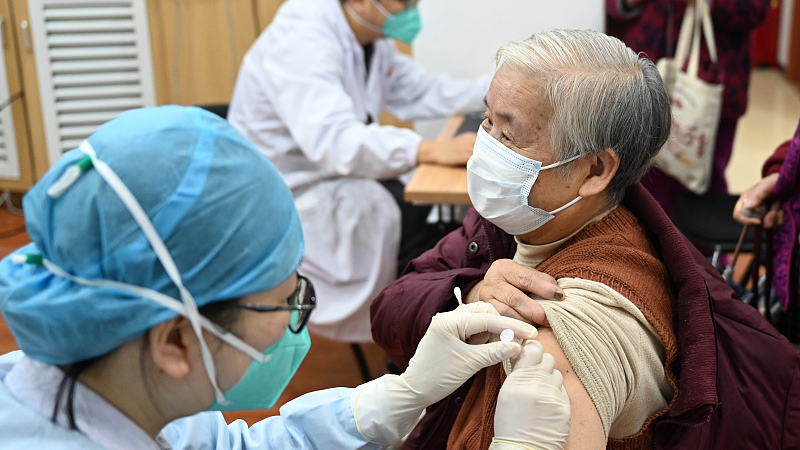 An elderly receives a COVID-19 vaccine in Hangzhou, Zhejiang Province, December 8, 2022. /CFP