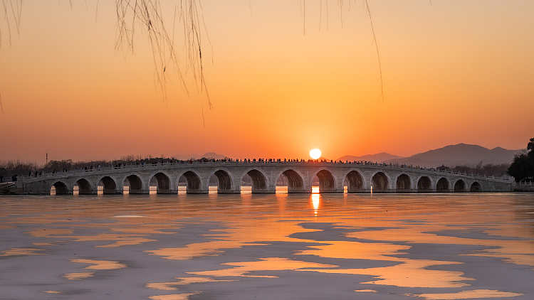 Live: Seventeen-arch Bridge lights up at sunset in Summer Palace