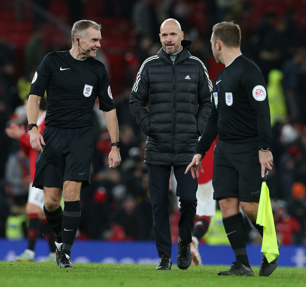 Manchester United manager Erik ten Hag (C) talks to referees after the League Cup fourth-round match between Manchester United and Burnley at Old Trafford in Manchester, England, December 21, 2022. /CFP