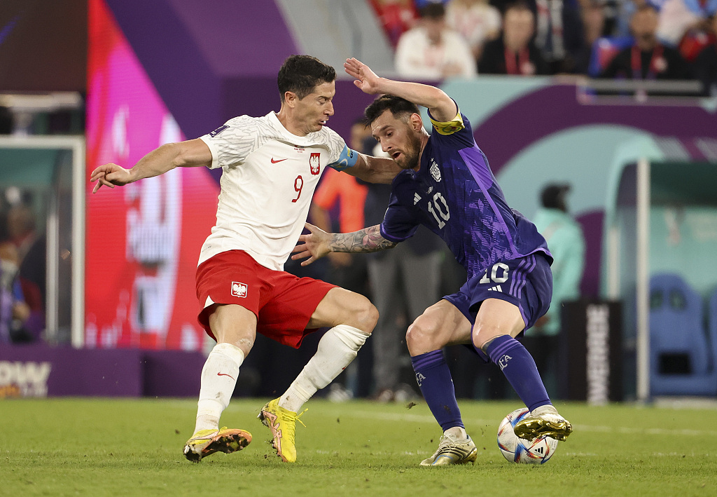 Argentina captain Lionel Messi (R) and Robert Lewandowski of Poland fight for the ball during their World Cup clash at Stadium 974 in Doha, Qatar, November 30, 2022. /CFP