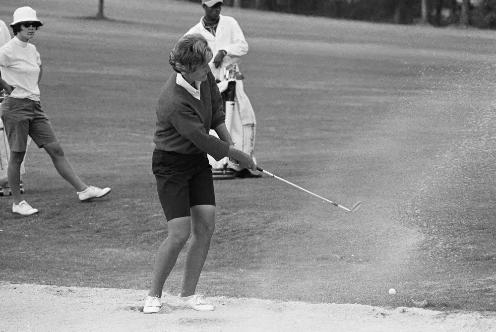 Kathy Whitworth blasts out of sand trap on the 18th green and then sinks a 6-foot putt to go into the lead of the Women Titleholders Golf Tournament at Augusta, U.S., November 25, 1966. /AP 
