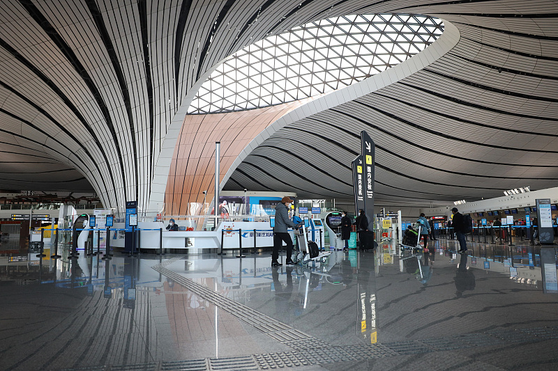 Travelers are seen in Beijing Daxing International Airport in Beijing, China, December 8, 2022. /CFP
