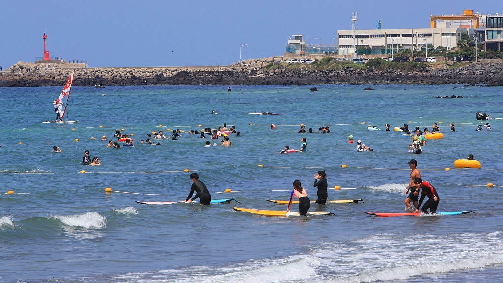 Vacationers spend time at Samyang Beach in South Korea's Jeju Province, July 9, 2022. /CFP