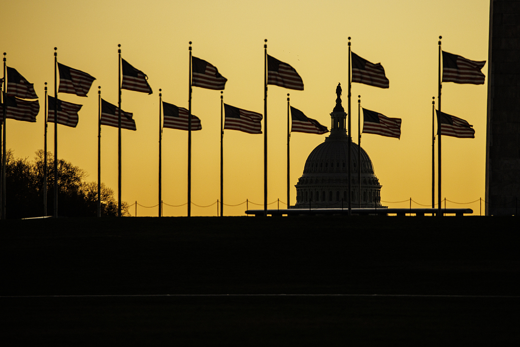The U.S. Capitol dome is seen past the base of the Washington Monument as the sun rises in Washington, D.C., November 9, 2022. /CFP