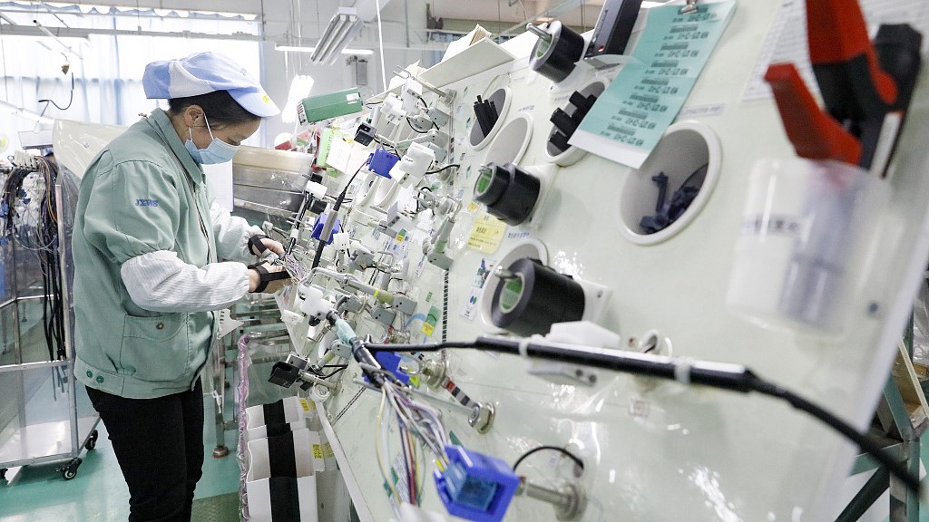 A worker produces electrical equipment at a company in East China's Jiangxi Province, December 26, 2022. /CFP