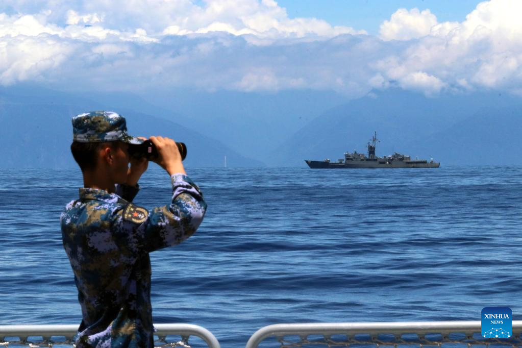 A soldier looks through binoculars during combat exercises and training of the navy of the Eastern Theater Command of the PLA in the waters around Taiwan Island, August 5, 2022. /Xinhua