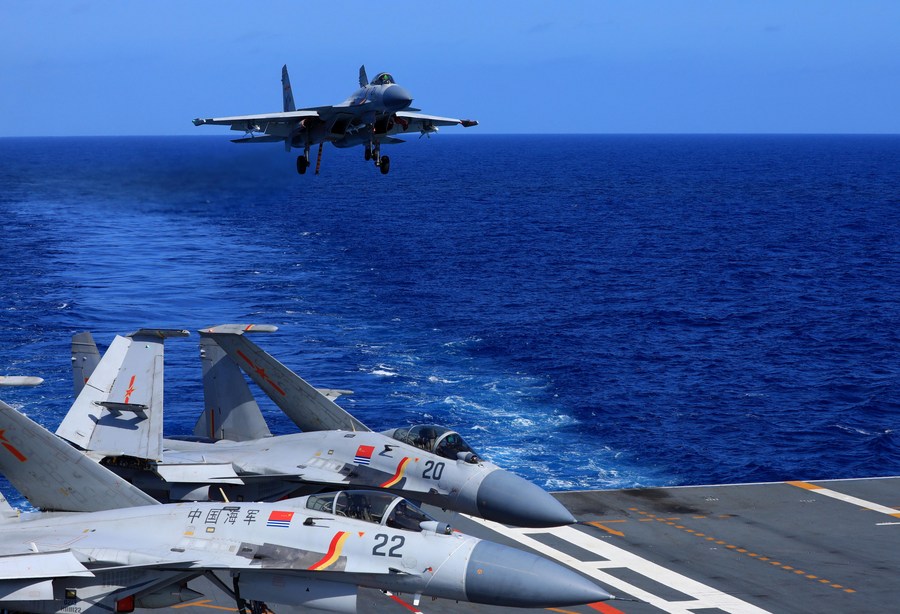 This undated photo shows a carrier-based J-15 fighter jet preparing to land during open-sea combat training. /Xinhua