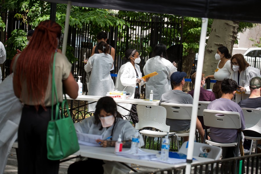 Healthcare workers assist people waiting to be vaccinated at a monkeypox vaccination site in New York, U.S., July 14, 2022. /Xinhua