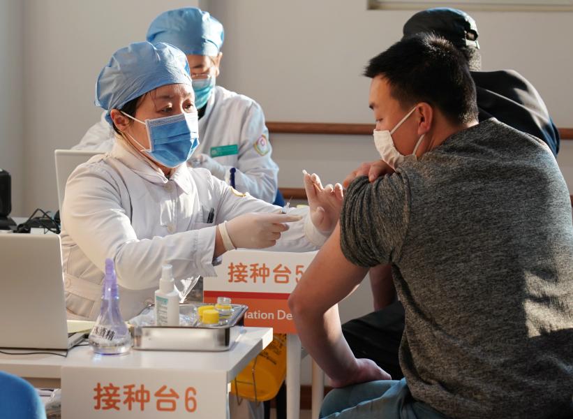 People are inoculated with the COVID-19 vaccines at a healthcare center in Honglian Community in Xicheng District of Beijing, capital of China, Jan. 3, 2021. /Xinhua