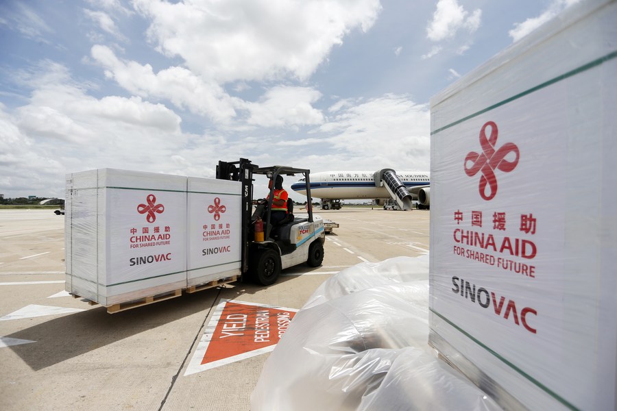 An airport worker transports packages of Sinovac COVID-19 vaccine at Phnom Penh International Airport in Phnom Penh, Cambodia on Oct. 14, 2021. /Xinhua
