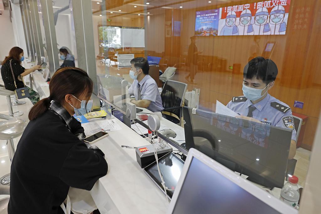 A woman applies for the endorsement to visit the Hong Kong Special Administrative Region in the Changning District branch of the Entry Exit Bureau in Shanghai, China, September 23, 2020. /CFP