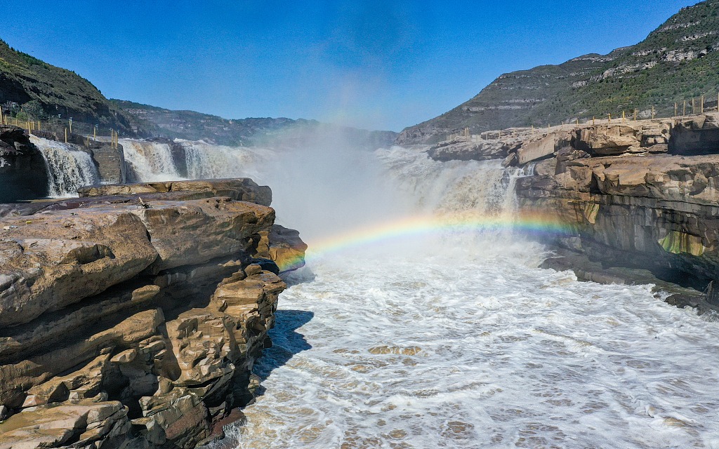 A bright rainbow was photographed over the Yellow River's Hukou Waterfall in Yan'an, northwest China's Shaanxi in October 2022. /CFP