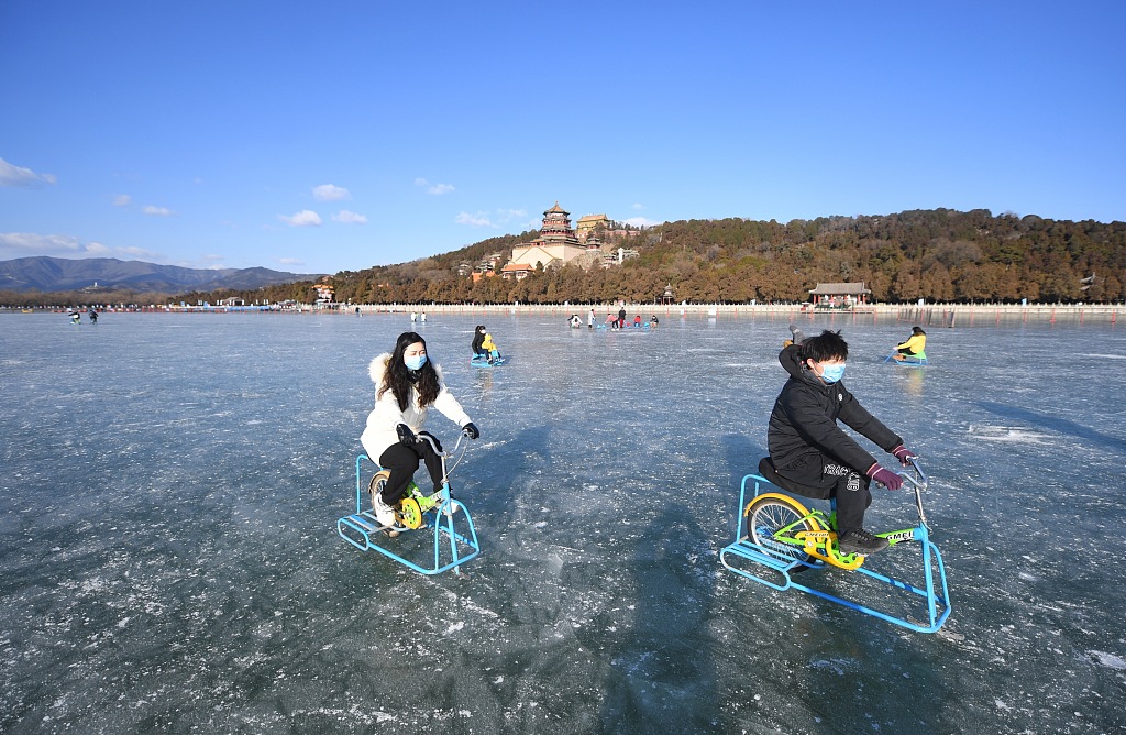 Beijing's largest natural ice rink, located at the Summer Palace, opened on January 10, ahead of the 2022 Beijing Winter Olympics. Visitors were pictured enjoying ice cycling and chair sleds in the 300,000-square-meter area. /CFP
