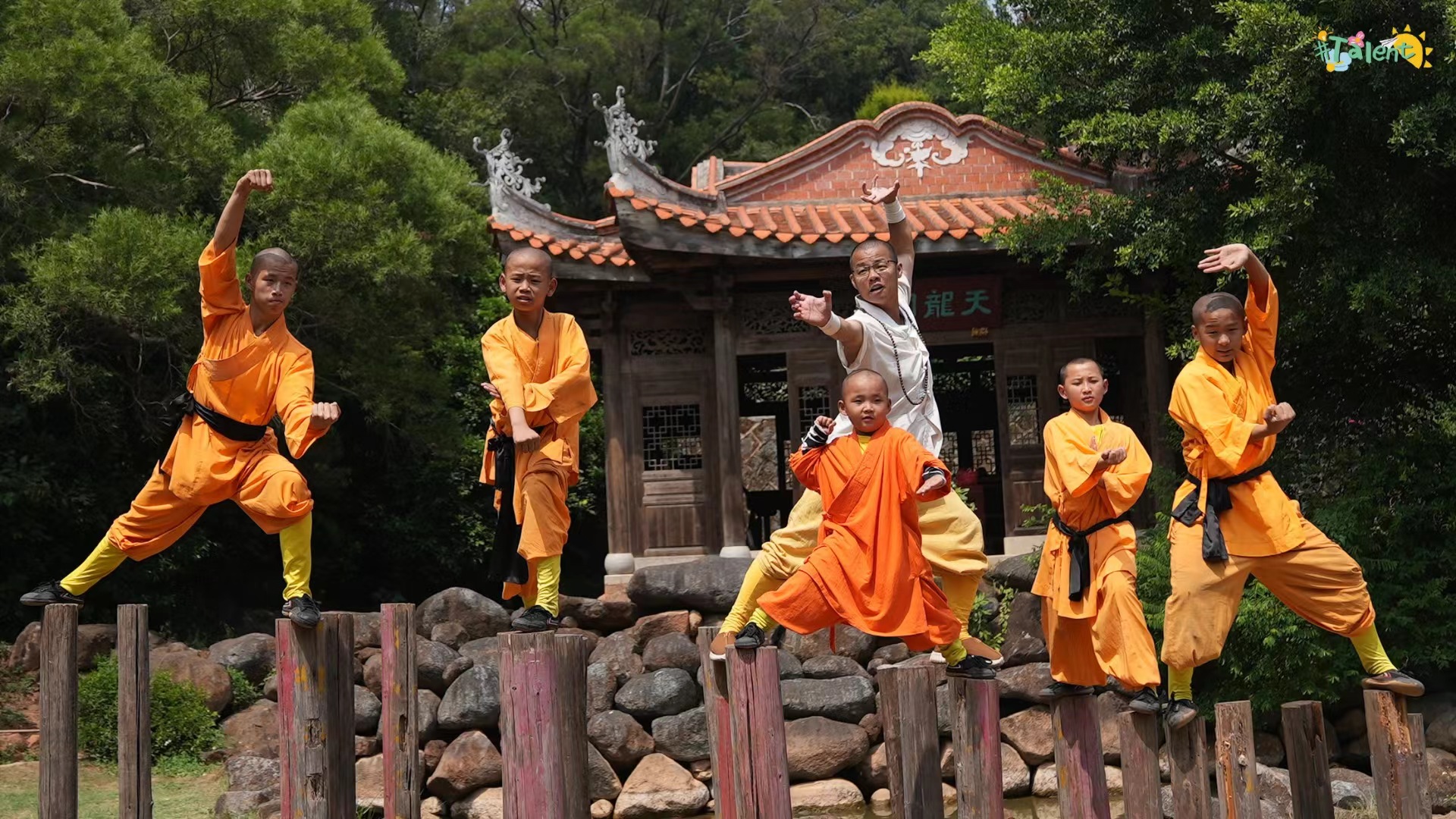 Kung fu pupils practice with their master on the wooden blocks at the Southern Shaolin Temple in Quanzhou.