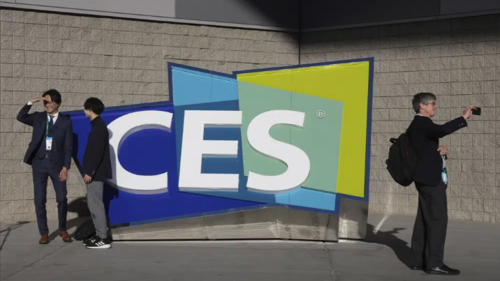 People take pictures in front of a sign during last CES tech show in Las Vegas, U.S., January 6, 2022. /AP