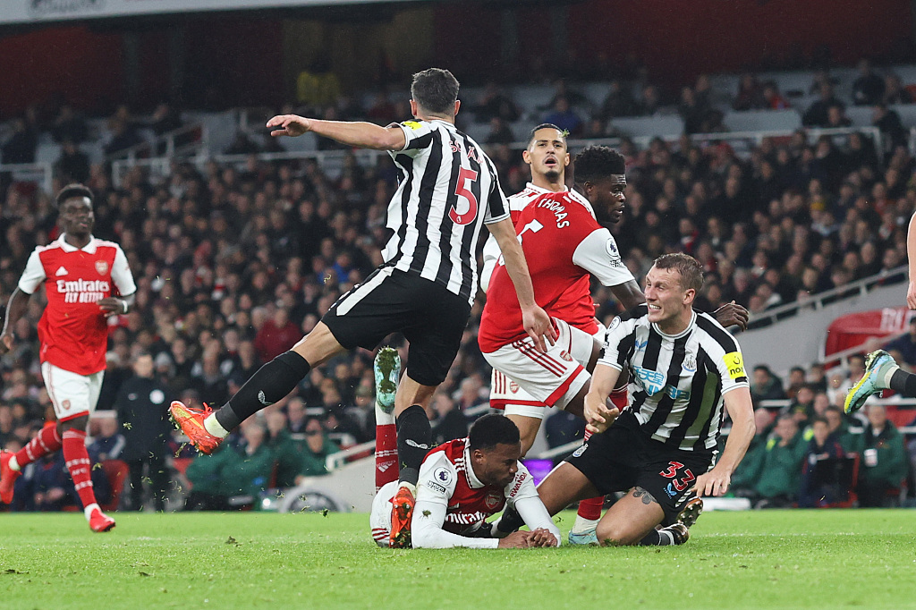 Gabriel of Arsenal falls over Dan Burn (#33) of Newcastle United resulting in the Newcastle player making an unsuccessful penalty shout during their Premier League clash at Emirates Stadium in London, England, January 3, 2023. /CFP
