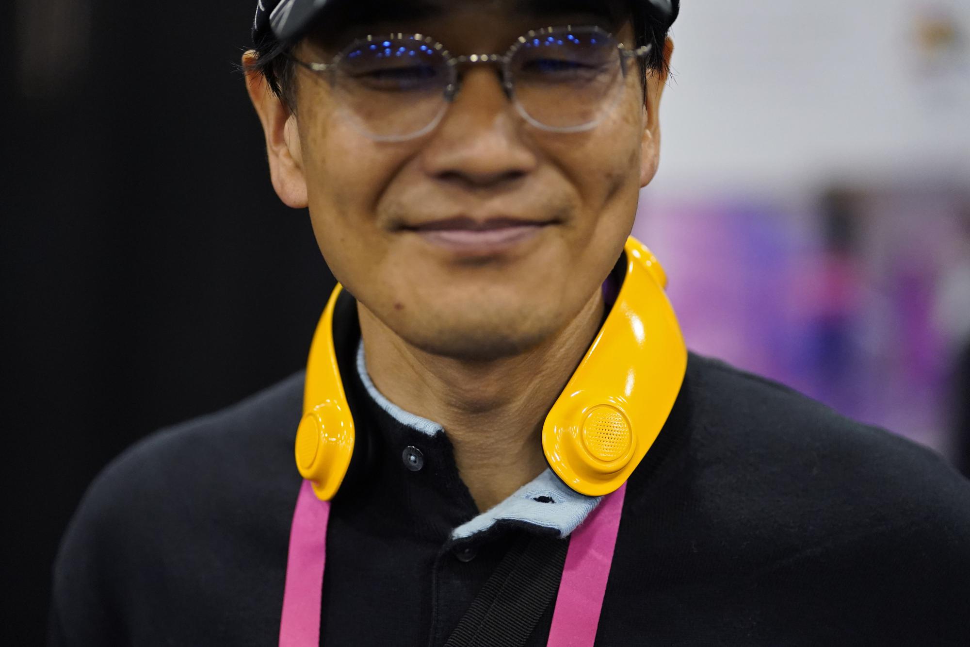 Exhibitor Toru Yamanka wears a Loovic augmented reality device during CES Unveiled. /AP