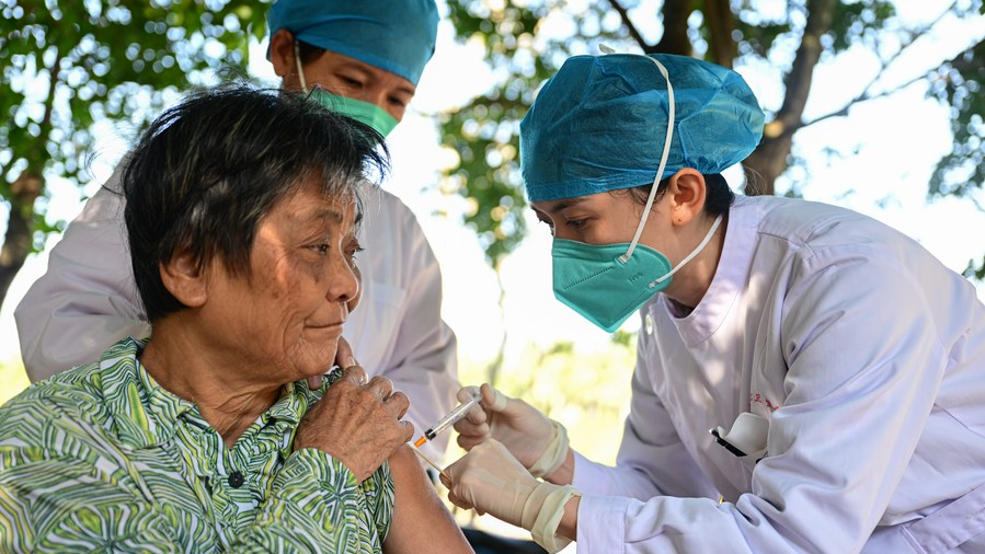 A medical worker administers a dose of a COVID-19 vaccine to a senior resident in Hufeng Village of Wenchang, south China's Hainan Province, December 22, 2022. /Xinhua