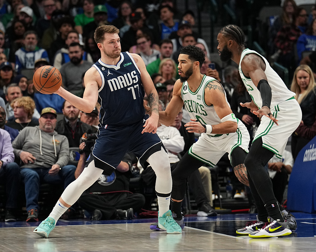 Luka Doncic (L) of the Dallas Mavericks passes in the game against the Boston Celtics at American Airlines Center in Dallas, Texas, January 5, 2023. /CFP